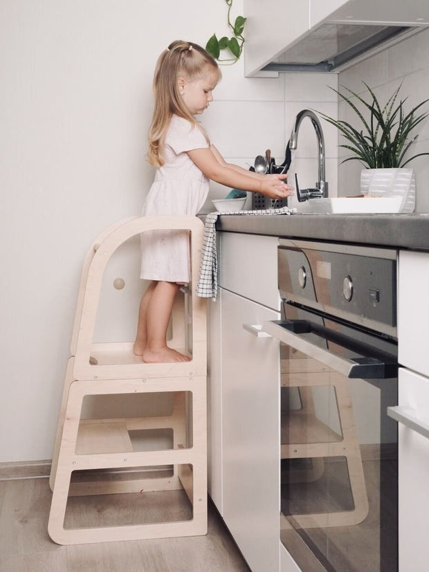 All-in-one learning tower with seating and play surface