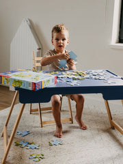 Kid exploring blue sensory table.