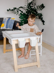 Durable table with sensory bins.