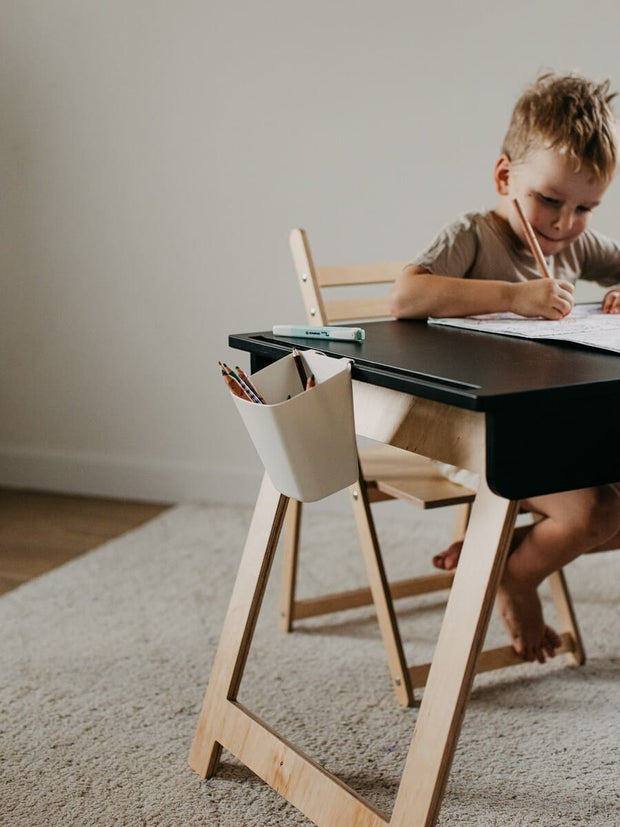 Toddler exploring wooden activity table.