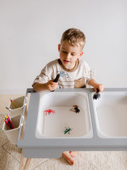 Sensory table with storage compartments.