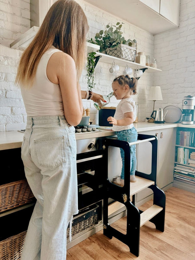 Handcrafted wooden step stool with a convertible learning tower design.