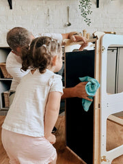 Minimalist wooden toddler learning tower for hands-on learning.