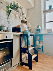 Foldable Montessori learning tower with a space-saving design.